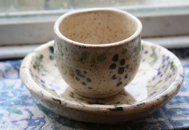 pot on saucer with dotty grapes